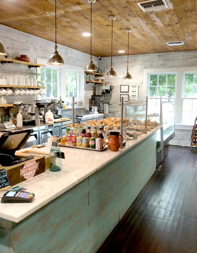 Cozy cafe interior with wooden ceiling and pastry display